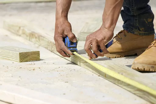 A beam is measured and marked at a housing site in Madison County, Miss., Tuesday, March 16, 2021. Homeowners may be reconsidering their remodeling plans this year because of the economy’s recent turbulence, but planning and prioritizing can help you accomplish projects with confidence. (AP Photo/Rogelio V. Solis, File)