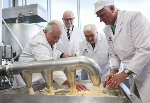 Britain's King Charles III, Dietmar Woidke, prime minister of Brandenburg, and German President Frank-Walter Steinmeier, from left, visit a cheese dairy in the Brodowin eco-village on the second day of the royal tour of Germany, Thursday, March 20, 2023. (Jens Buettner/DPA via AP, Pool)