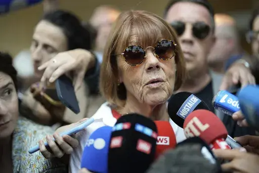 Gisele Pelicot speaks to media as she leaves the Avignon court house, southern France, Thursday, Sept. 5, 2024. (AP Photo/Lewis Joly, File)
