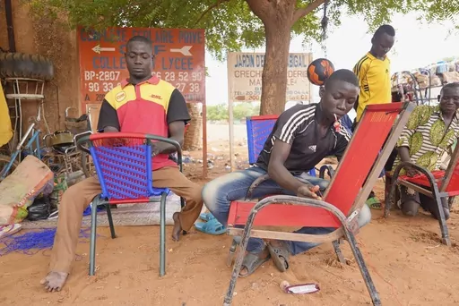 Nigerian men repair chairs in Niamey, Niger, Tuesday, Aug. 15, 2023. Niger, an impoverished country of some 25 million people, was seen as one of the last countries that Western nations could partner with in Africa's Sahel region to beat back a jihadi insurgency linked to al-Qaida and the Islamic State group. Before last month's coup, Europe and the United States had poured hundreds of millions of dollars into propping up its military. (AP Photo/Sam Mednick)