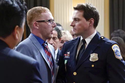 Stephen Ayres, who pleaded guilty last in June 2022 to disorderly and disruptive conduct in a restricted building, shakes hands with Washington Metropolitan Police Department officer Daniel Hodges as the hearing with the House select committee investigating the Jan. 6 attack on the U.S. Capitol, concludes at the Capitol in Washington, Tuesday, July 12, 2022. (AP Photo/Jacquelyn Martin)