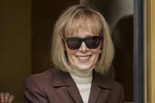 E. Jean Carroll walks out of federal court in Manhattan, May 9, 2023, in New York. The Justice Department on Tuesday, July 11, 2023, said that former President Donald Trump can be held personally liable for remarks he made about a Carroll, who accused him of rape, a reversal of its position that Trump was protected because he was president when he made the remarks. (AP Photo/John Minchillo, File)