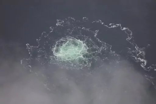 In this picture provided by Swedish Coast Guard, a small release from Nord Stream 2 is seen, Wednesday, Sept. 28, 2022. A fourth leak on the Nord Stream pipelines has been reported off southern Sweden.  The Kremlin and Russian state media are aggressively pushing a baseless conspiracy theory blaming the United States for damage to natural gas pipelines in the Baltic Sea in what analysts said Friday, Sept. 30, is another effort to split the U.S. and its European allies.(Swedish Coast Guard via AP