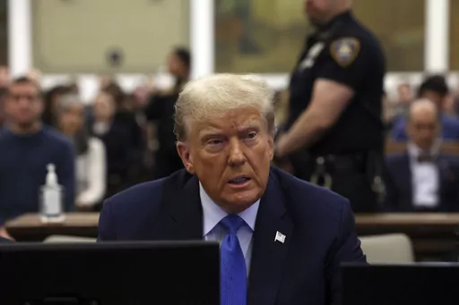 Former President Donald Trump waits to take the witness stand during his civil fraud trial at New York Supreme Court, Monday, Nov. 6, 2023, in New York. A judge in Michigan is expected to hear arguments as to whether or not Secretary of State Jocelyn Benson has the authority to keep Trump’s name off any state ballot for president. Activists are suing Benson in the Michigan Court of Claims to force her to keep Trump’s name off ballots.(Brendan McDermid/Pool Photo via AP)