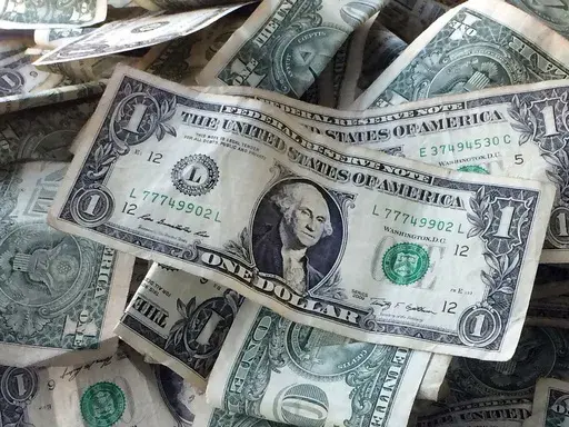 This Oct. 24, 2016 file photo shows dollar bills in New York. (AP Photo/Mark Lennihan, File)
