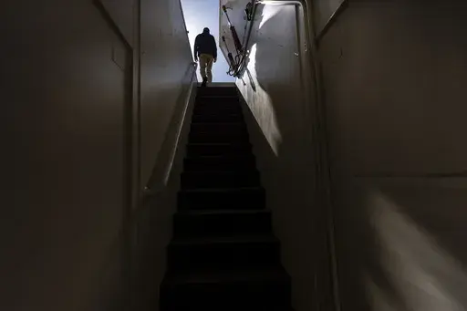 The owner, who asked not to be identified because of concerns about his privacy, walks up the steps of his underground shelter in an undisclosed Southern California city, on Dec. 16, 2024. (AP Photo/Jae C. Hong)