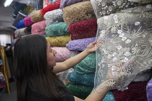 A hand-embroidery dress fabric made in India, costing a couple hundred dollars per yard, is sold at the Francia Textiles fabric store in the Fashion District in Los Angeles on Thursday, April 3, 2025. (AP Photo/Damian Dovarganes)
