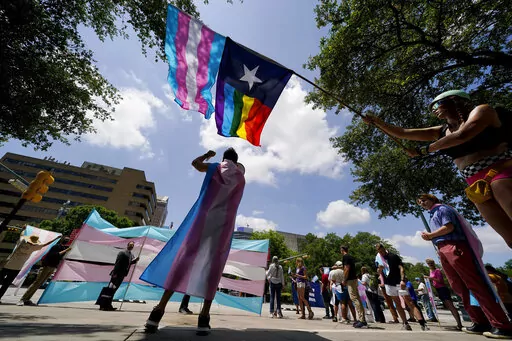 Demonstrators gather on the steps to the State Capitol to speak against transgender-related legislation bills being considered in the Texas Senate and Texas House, Thursday, May 20, 2021 in Austin, Texas. A Texas judge on Friday, March 11, 2022 blocked the state from investigating as child abuse gender confirming care for transgender youth. District Judge Amy Clark Meachum issued a temporary injunction preventing the state from enforcing Republican Gov. Greg Abbott’s directive to compel the De
