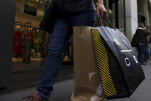 A shopper carries bags down Fifth Avenue on Friday, Nov. 25, 2022, in New York. If you bought an unsuccessful gift this holiday season with a “buy now, pay later” plan, you or the recipient might be wondering how to return it. Buy now, pay later returns are sometimes tricky because you’re dealing with multiple parties, including the store the gift is from and the buy now, pay later provider that financed the purchase. (AP Photo/Julia Nikhinson, File)