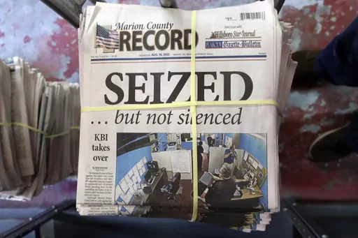 A stack of the latest weekly edition of the Marion County Record sits in the back of the newspaper's building, awaiting unbundling, sorting and distribution, Wednesday, Aug. 16, 2023, in Marion, Kan. The newspaper's front page was dedicated to two stories about a raid by local police on its offices and the publisher's home on Aug. 11, 2023. (AP Photo/John Hanna)