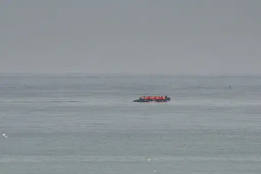 FILE- A boat thought to be with migrants is seen in the sea near the Wimereux beach, France, on Sept. 4, 2024. (AP Photo/Nicolas Garriga, File)