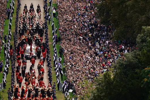 The Ceremonial Procession of the coffin of Queen Elizabeth II travels down the Long Walk as it arrives at Windsor Castle for the Committal Service at St George's Chapel, in Windsor, England, Monday, Sept. 19, 2022. (Aaron Chown/Pool photo via AP)