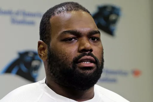 Carolina Panthers' Michael Oher speaks to the media during the first day of their NFL football offseason conditioning program in Charlotte, N.C., April 20, 2015. Oher, the former NFL tackle known for the movie “The Blind Side,” filed a petition Monday, Aug. 14, 2023, in a Tennessee probate court accusing Sean and Leigh Anne Tuohy of lying to him by having him sign papers making them his conservators rather than his adoptive parents nearly two decades ago.(AP Photo/Chuck Burton, File)