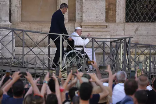 FILE-- Pope Francis greets the faithful as he leaves St. Mary Major Basilica after participating in a rosary prayer for peace, in Rome, Tuesday, May 31, 2022. Pope Francis canceled a planned July trip to Africa on doctors' orders because of ongoing knee problems, the Vatican said Friday, June 10, 2022, raising further questions about the health and mobility problems of the 85-year-old pontiff.  (AP Photo/Gregorio Borgia)