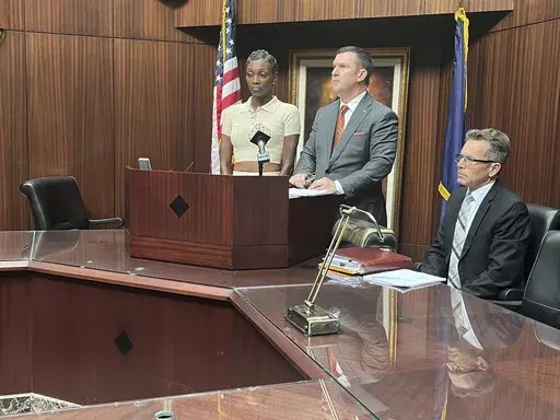 Latoreya Till, left, the mother of a 15-year-old girl who fell asleep in the Detroit courtroom of 36th District Court Judge Kenneth King, while on an Aug. 13 field trip, is suing the judge according to her attorney James Harrington, center, as they speak at a press conference in Southfield, Mich., Wednesday, Aug. 21, 2024. (Kara Berg/Detroit News via AP)