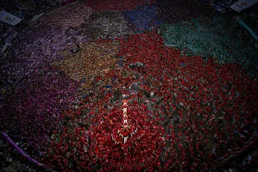 Members of "Colla Joves Xiquets de Valls" form a "Castell" or human tower, during the 29th Human Tower Competition in Tarragona, Spain, Sunday, Oct. 6, 2024. (AP Photo/Emilio Morenatti)