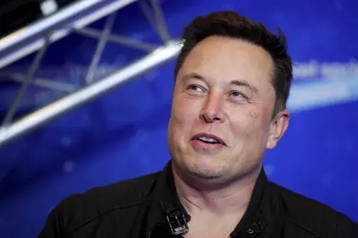 Tesla and SpaceX CEO Elon Musk arrives on the red carpet for the Axel Springer media award in Berlin on Dec. 1, 2020. Musk suggested in a Saturday, Oct. 15, 2022, tweet that his rocket company SpaceX may continue to fund its satellite-based Starlink internet service in Ukraine. But Musk's tone and wording also raised the possibility that the irascible Tesla CEO was just being sarcastic. (Hannibal Hanschke/Pool Photo via AP, File)