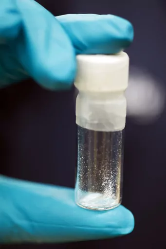 A vial containing 2mg of fentanyl, is displayed at the Drug Enforcement Administration (DEA) Special Testing and Research Laboratory in Sterling, Va., Aug. 9, 2016. The US is announcing a series of indictments and sanctions against 14 people and 14 firms across China and Canada related to the import of fentanyl into the United States. It's one of the biggest actions the Biden administration has taken against the trafficking of the deadly drug. (AP Photo/Cliff Owen, File)
