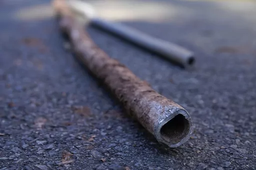 Lead water pipes pulled from underneath the street are seen in Newark, N.J., Oct. 21, 2021. (AP Photo/Seth Wenig, File)