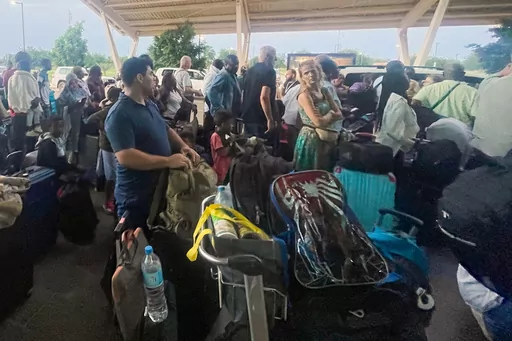 French and other nationals gather at the international Airport to be airlifted back to France on a French military aircraft, in Niamey, Niger, Wednesday, Aug. 2, 2023, to be airlifted back to France on a French military aircraft. French forces in the capital, Niamey, evacuated hundreds of mostly French nationals to Paris on two flights Tuesday, following concerns that their citizens and other Europeans risked becoming trapped by last week’s military coup, which ousted and detained President Mo