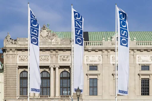 Flags wave in the wind in front of the entrance of the Permanent Council of the Organization for Security and Cooperation in Europe, OSCE, in Vienna, Austria, Feb. 15, 2022. Neutral Austria has come under heavy criticism for granting visas to sanctioned Russian lawmakers for a meeting of the Organization for Security and Cooperation in Europe in Vienna from Feb. 23 until Feb. 24, 2023. The issue highlights the delicate balancing act the European country has engaged in while trying to maintain it