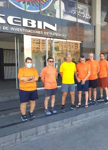 This undated file photo posted on Twitter on June 18, 2020 by Venezuela's Foreign Minister Jorge Arreaza, shows CITGO oil executives Jose Angel Pereira, from left to right, Gustavo Cardenas, Jorge Toledo, Jose Luis Zambrano, Tomeu Vadell and Alirio Jose Zambrano, standing outside the Bolivarian National Intelligence Service, in Caracas, Venezuela. A court in Venezuela on Friday, Feb. 4, 2022, has upheld the prison sentences for the six American oil executives on corruption charges. (Posted on Tw