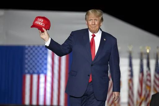 Former President Donald Trump makes his entrance at a rally at the Minden Tahoe Airport in Minden, Nev.,  Oct. 8, 2022. Trump angrily lashed out Wednesday, Oct. 12, calling the nation's legal system a “broken disgrace" after a judge ruled he must answer questions under oath next week in a defamation lawsuit lodged by a writer who says he raped her in the mid-1990s. (AP Photo/José Luis Villegas, Pool, File)