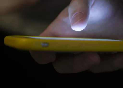 A person uses a cell phone in New Orleans on Aug. 11, 2019. On Friday, Sept. 29, 2023, The Associated Press reported on stories circulating online incorrectly claiming an emergency broadcast system test on Oct. 4 will send a signal to cell phones nationwide in order to activate nanoparticles such as graphene oxide that have been introduced into people’s bodies. (AP Photo/Jenny Kane, File)