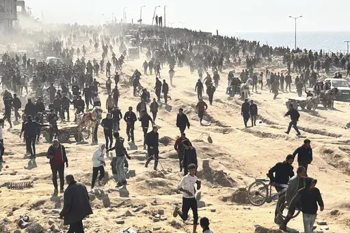 Palestinians wait for humanitarian aid on a beachfront in Gaza City, Gaza Strip, Sunday, Feb. 25, 2024. Israel and Hamas are inching toward a new deal that would free some of the roughly 130 hostages held in the Gaza Strip in exchange for a weeks-long pause in the war, now in its fifth month. A deal would bring some respite to desperate people in Gaza, who have borne a staggering toll in the war, as well as to the anguished families of hostages taken during Hamas' Oct. 7 attack that sparked the 