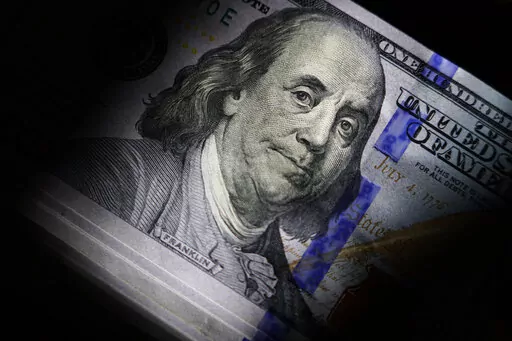 The likeness of Benjamin Franklin is seen on U.S. $100 bills, Thursday, July 14, 2022, in Marple Township, Pa.  Debt can derail a person’s financial goals and take a toll on their mental health. And if they’ve been turning to you or others for money, those struggles can spread quickly. But as a close friend or relative, you have the potential to set them on the right course.  (AP Photo/Matt Slocum)