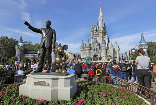 In this Jan. 9, 2019 photo, a statue of Walt Disney and Micky Mouse stands in front of the Cinderella Castle at the Magic Kingdom at Walt Disney World in Lake Buena Vista, Fla. The Walt Disney Co. will be laying off several thousand employees in the week starting Monday, April 24, 2023, a second round of cuts that's part of a previously announced plan to eliminate 7,000 jobs this year. (AP Photo/John Raoux)
