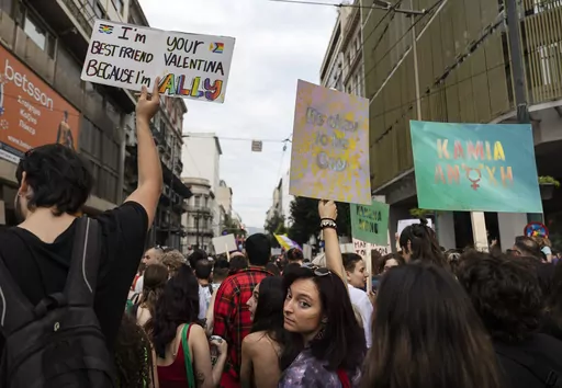 People raise placards as they participate in the annual Pride parade, in Athens, on June 10, 2023. Greece's center-right government said on Thursday, Dec. 21, 2023, it would fulfill a commitment to legalize same-sex marriage, sidestepping staunch opposition from the country's influential Orthodox Church. (AP Photo/Yorgos Karahalis, File)