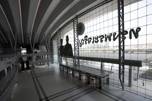 A lone passenger walks outside the main entrance of the Krung Thep Aphiwat Central Terminal in Bangkok, Thailand, Tuesday, Jan. 17, 2023. Thailand ushered in a new age of train travel on Thursday when what’s said to be Southeast Asia’s biggest railway station officially began operations. (AP Photo/Sakchai Lalit)
