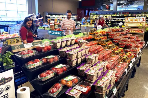 Shoppers shop at a grocery store in Glenview, Ill., Monday, July 4, 2022.  U.S. demand for grocery delivery is cooling as food prices rise. Some shoppers are shifting to less expensive grocery pickup, while others are returning to the store. (AP Photo/Nam Y. Huh)