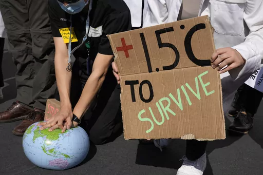 Demonstrators pretend to resuscitate the Earth while advocating for the 1.5 degree warming goal to survive at the COP27 U.N. Climate Summit, Nov. 16, 2022, in Sharm el-Sheikh, Egypt. Worldwide temperatures briefly exceeded a key warming threshold earlier this month, drawing notice from scientists and experts who warned of more extremes ahead as the planet enters an El Nino phase. (AP Photo/Peter Dejong, File)