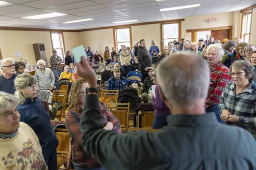 Bruce Olson gives instructions on how to vote to residents attending the annual Town Meeting, Tuesday, March 5, 2024, in Elmore, Vt. Democracy takes many forms, and some are more direct than others. In Elmore, the tradition of Town Meeting is very direct and the business of running a town and participating in its administration was thrown open to everyone for the yearly meeting today. The nuts and bolts of town business and decision-making get done, and in the process something unfolds that does