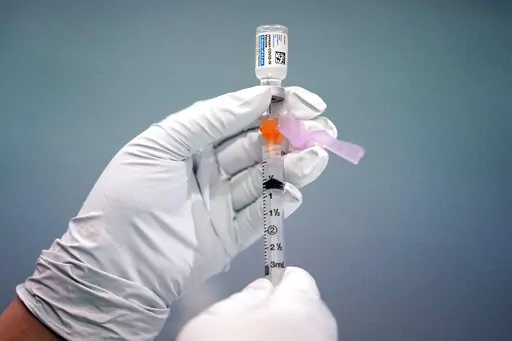 A member of the Philadelphia Fire Department prepares a dose of the Johnson & Johnson COVID-19 vaccine at a vaccination site setup in Philadelphia, on March 26, 2021. On Friday, April 29, The Associated Press reported on stories circulating online incorrectly claiming a recent outbreak of unexplained hepatitis cases among children is being caused by the adenovirus vector used in some COVID-19 vaccines, including the Johnson & Johnson shot.(AP Photo/Matt Rourke, File)