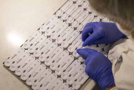 A employees works at NG Biotech, a start-up that makes an array of medical tests, including kits for use at home and by medical professionals to detect COVID-19 infections , in Guipry, western France, Friday, Jan. 7, 2022. With France breaking records in Europe for coronavirus infections, manufacturers are working flat-out to try to meet the huge demand for tests. (AP Photo/Jeremias Gonzalez)