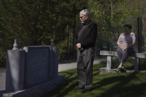 Co-presidents of New Light Congregation, Stephen Cohen and Barbara Caplan, visit a memorial in the New Light Cemetery on Wednesday, April 19, 2023, in Shaler Township, Pa., honoring the congregants they lost during the Pittsburgh synagogue massacre over four years ago. Jury selection is scheduled to begin on Monday, April 24, for the suspect accused of invading the Tree of Life synagogue building on that Sabbath morning and murdering 11 worshippers from three congregations. (AP Photo/Jessie Ward