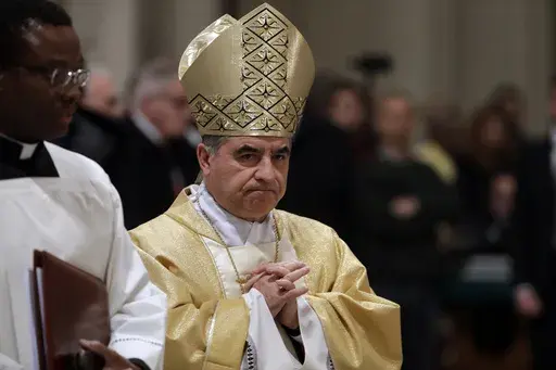 Mons. Giovanni Angelo Becciu presides over an eucharistic liturgy, at the St. John in Latheran Basilica, in Rome, Thursday, Feb. 9, 2017. The Vatican's chief prosecutor has appealed a court verdict that, while finding a cardinal guilty of embezzlement, largely dismantled his theory of a grand conspiracy to defraud the Holy See of millions of euros.(AP Photo/Gregorio Borgia, File )