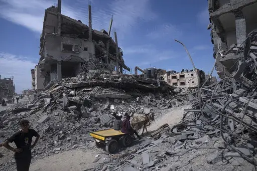 Palestinians salvage what they can from the destruction left by Israeli troops in Khan Younis, southern Gaza Strip, on April 8, 2024. (AP Photo/Fatima Shbair, File)