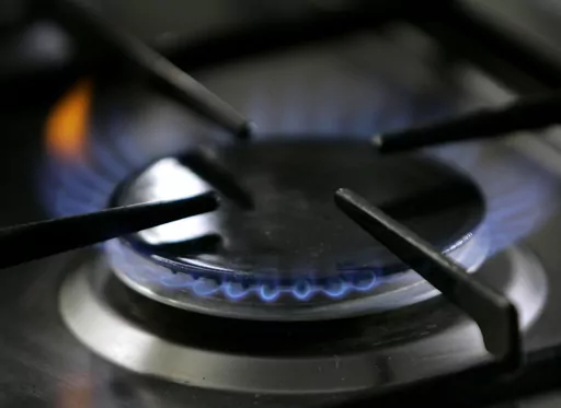 A gas-lit flame burns on a natural gas stove on Jan. 11, 2006. The Republican-controlled House is taking up legislation that GOP lawmakers say would protect gas stoves from over-zealous government regulators. (AP Photo/Thomas Kienzle, File)