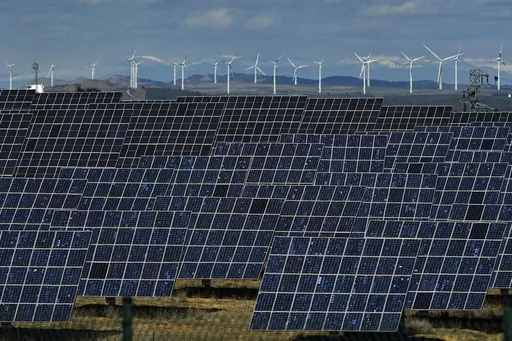 Solar panels work near the small town of Milagro, Navarra Province, northern Spain, on Feb. 24, 2023. Renewable energy investors who lost subsidies promised by Spain are heading to a London court to try to claw back $125 million from the government — a decadelong dispute with ramifications for clean energy financing across the European Union. (AP Photo/Alvaro Barrientos, File)