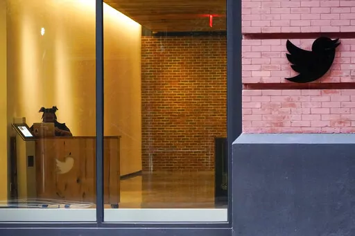 A receptionist works in the lobby of the building that houses the Twitter office in New York, Wednesday, Oct. 26, 2022. On Thursday, Nov. 17, 2022, Twitter continued to bleed engineers and other workers after new owner Elon Musk gave them a choice to pledge to “hardcore” work or resign with severance pay. (AP Photo/Mary Altaffer, File)