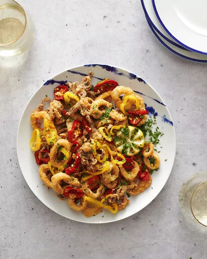 This image shows a recipe for Rhode Island–Style Fried Calamari  by Dan Rinaldi, a firefighter in Providence, R.I., from “The Great American Recipe Cookbook," a new PBS series that gathers 10 home cooks from all over the country and gives them the opportunity to showcase their beloved signature dishes. (Fred + Elliott via AP)