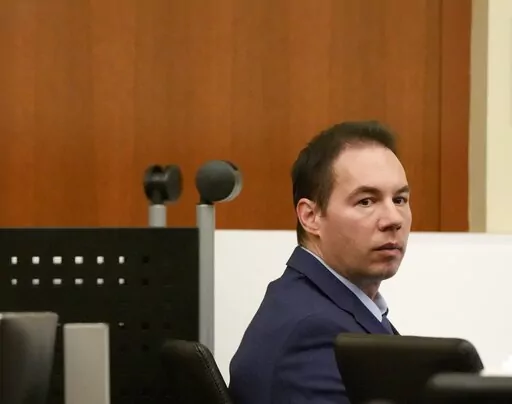 William Husel sits during his trial Monday, Feb. 28, 2022, in Columbus, Ohio.  Despite being found innocent of murder charges related to multiple patient deaths, Husel determined that practicing medicine again in Ohio would be impossible following a years-long ordeal and so chose to surrender his medical license, his attorney said, Thursday, May 12.
 Husel, 46, was acquitted last month of 14 counts of murder following accusations that he ordered excessive amounts of painkillers for patients in 