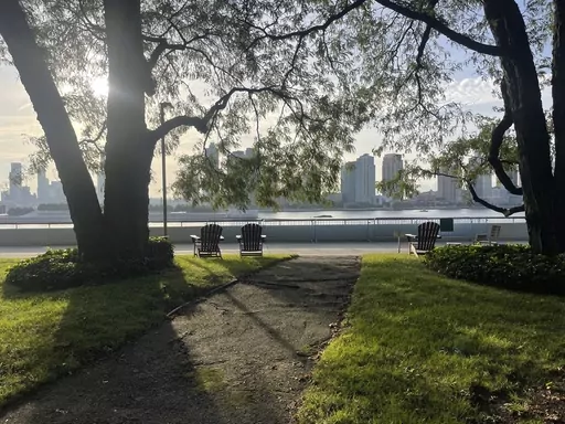 Chairs for contemplation look out upon the East River inside the U.N. compound in New York on Friday, Sept. 22, 2023. The parklet in the U.N. compound is a place where people go to find a few minutes of peace just yards from the buildings where leaders and diplomats deal with the world’s chaos. (AP Photo/Ted Anthony)