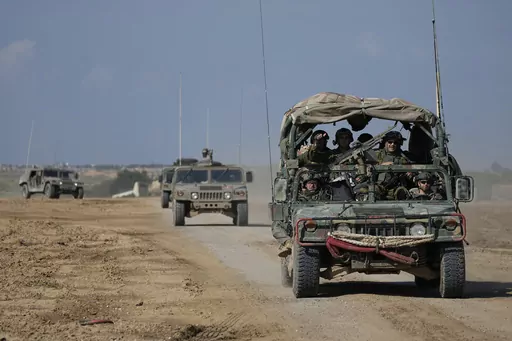 Israeli forces move near the Gaza Strip border in southern Israel, Thursday, Jan. 25, 2024. The army is battling Palestinian militants across Gaza in the war ignited by Hamas' Oct. 7 attack into Israel. (AP Photo/Ohad Zwigenberg)