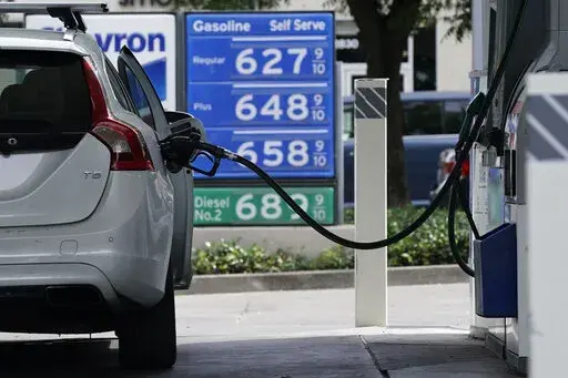 FILE— Gas is advertised for more than $6 per gallon at a gas station in Sacramento, Calif., Friday, May 27, 2022. Many California households could soon get help to pay for the state's record-high gas prices. Most California households would get up to $1,050 from the government to help them put the nation's most expensive gasoline in their cars, part of a relief package in the state's record-setting operating budget that lawmakers are scheduled to approve later this week. (AP Photo/Rich Pedronc