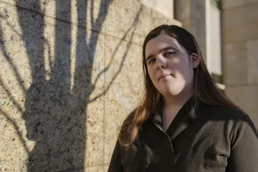 Mellow, a transgender woman, poses for a portrait, Monday, Feb. 3, 2025, outside of the Norfolk Circuit Court in Norfolk, Va., where she applied for a passport. (AP Photo/Stephanie Scarbrough)